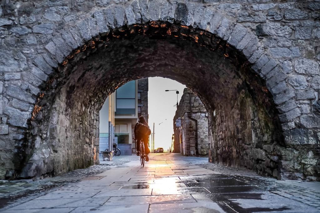 Photograph of the Spanish arch with a cyclist going through it